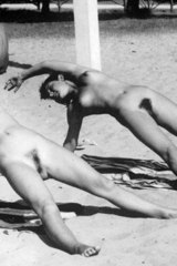 Flexible nudist girls in the sand